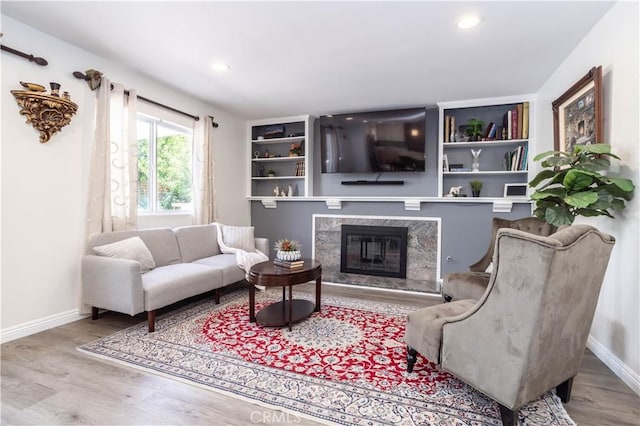 11721 Killimore Ave, Porter Ranch, CA 91326 - living room featuring wood finished floors, a premium fireplace, and recessed lighting