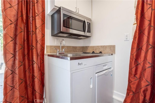 11721 Killimore Ave, Porter Ranch, CA 91326 - kitchen with stainless steel microwave and white cabinets