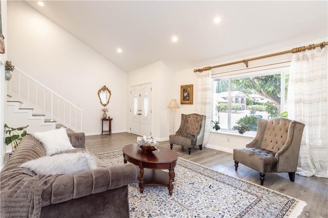 11721 Killimore Ave, Porter Ranch, CA 91326 - living area featuring wood finished floors, recessed lighting, high vaulted ceiling, and stairs