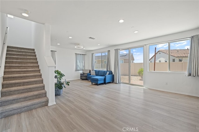 1415 Opal Ct, Beaumont, CA 92223 - living room featuring stairway, light wood-style flooring, and recessed lighting
