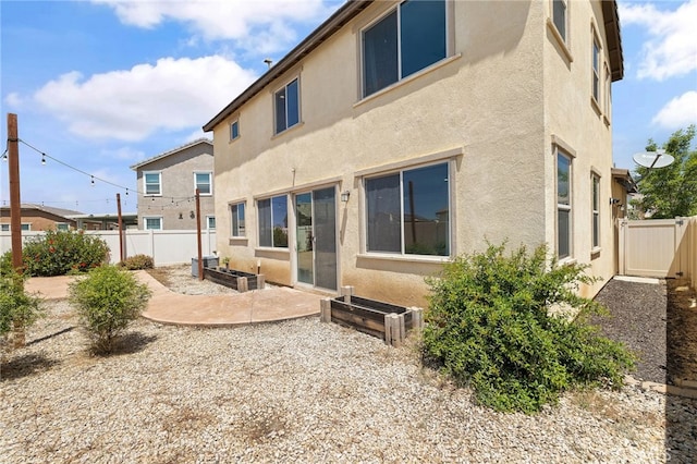 1415 Opal Ct, Beaumont, CA 92223 - rear view of property featuring stucco siding and a patio