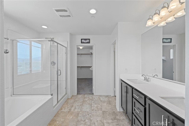 1415 Opal Ct, Beaumont, CA 92223 - full bathroom featuring double vanity, a stall shower, a spacious closet, a bath, and recessed lighting