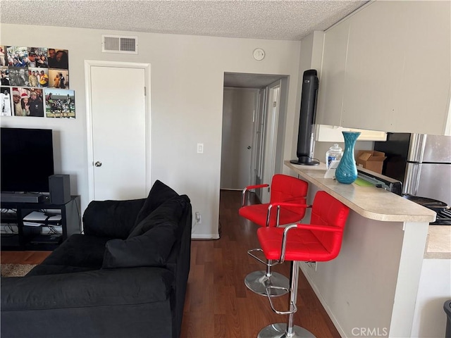 1549 W 146th St Unit 9, Gardena, CA 90247 - living area with wood finished floors and a textured ceiling