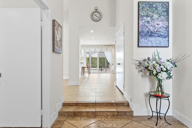 21211 Poston Ln, Huntington Beach, CA 92646 - hall featuring a towering ceiling, inlaid floor details, and tile patterned flooring