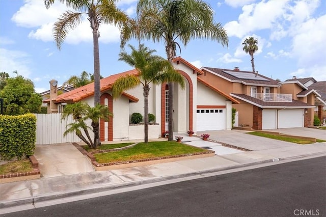 21211 Poston Ln, Huntington Beach, CA 92646 - view of front facade with stucco siding, driveway, and roof mounted solar panels