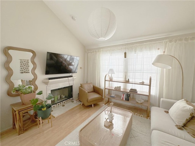 8655 Moody St, Cypress, CA 90630 - living area featuring wood finished floors, lofted ceiling, and a tile fireplace