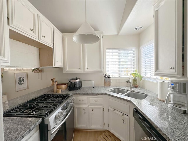 8655 Moody St, Cypress, CA 90630 - kitchen with appliances with stainless steel finishes, white cabinets, light stone countertops, and hanging light fixtures