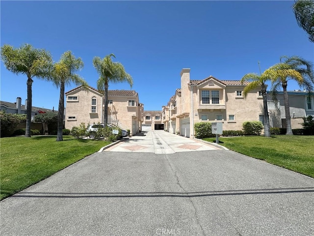 8655 Moody St, Cypress, CA 90630 - view of property with an attached garage, a residential view, and driveway