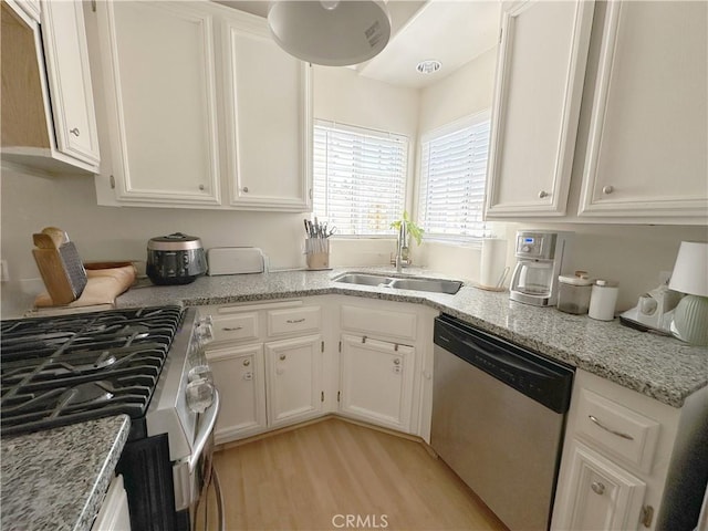 8655 Moody St, Cypress, CA 90630 - kitchen featuring stainless steel appliances, white cabinets, light wood finished floors, and light stone countertops