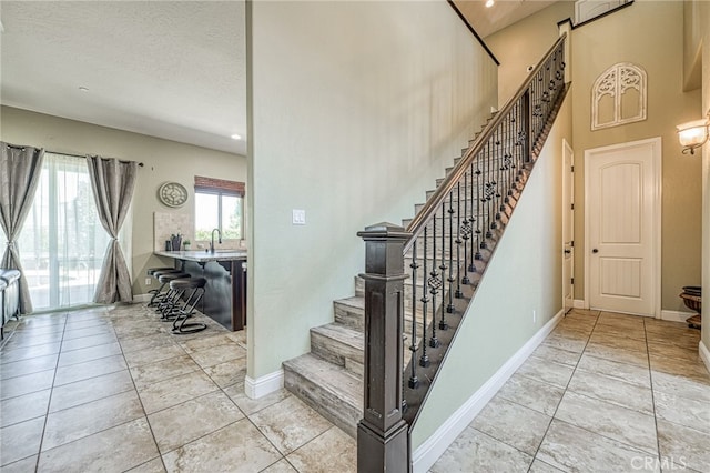 6626 W Alluvial Ave, Fresno, CA 93722 - staircase with tile patterned flooring and recessed lighting