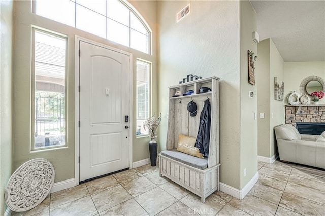 6626 W Alluvial Ave, Fresno, CA 93722 - foyer with tile patterned floors and a fireplace