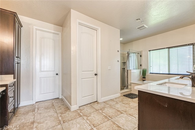 6626 W Alluvial Ave, Fresno, CA 93722 - kitchen with light countertops and dark brown cabinetry