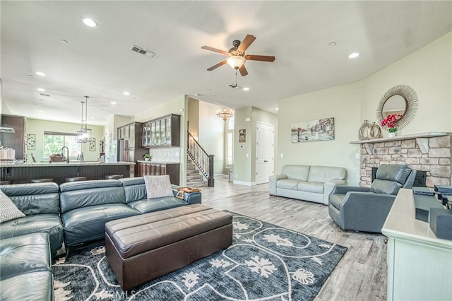 6626 W Alluvial Ave, Fresno, CA 93722 - living room with ceiling fan, stairway, light wood finished floors, recessed lighting, and a fireplace