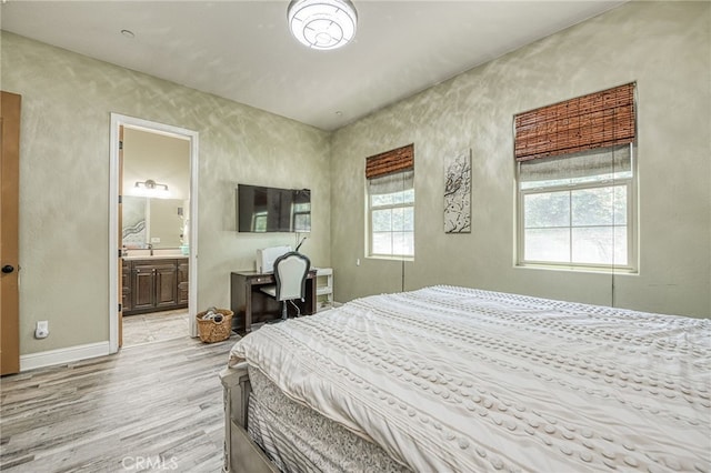 6626 W Alluvial Ave, Fresno, CA 93722 - bedroom with light wood-type flooring and baseboards