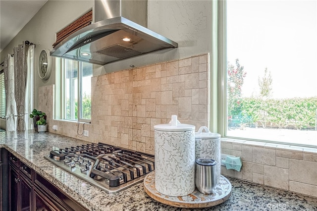 6626 W Alluvial Ave, Fresno, CA 93722 - kitchen featuring ventilation hood, stainless steel gas stovetop, light stone countertops, tasteful backsplash, and dark brown cabinetry