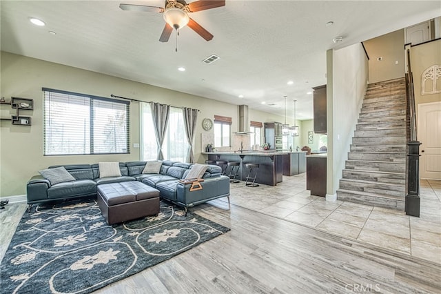 6626 W Alluvial Ave, Fresno, CA 93722 - living room with a ceiling fan, stairs, recessed lighting, and light wood finished floors