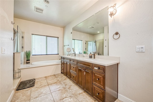 6626 W Alluvial Ave, Fresno, CA 93722 - full bathroom featuring a bath, double vanity, a shower with door, and a textured wall