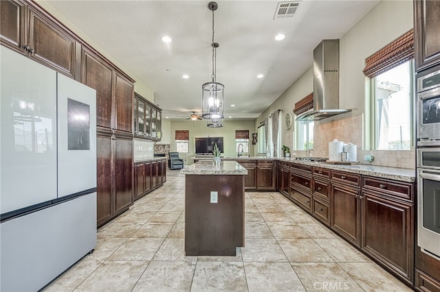 6626 W Alluvial Ave, Fresno, CA 93722 - kitchen with appliances with stainless steel finishes, recessed lighting, wall chimney range hood, decorative backsplash, and a ceiling fan