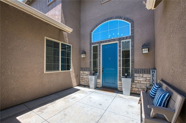 6626 W Alluvial Ave, Fresno, CA 93722 - view of exterior entry featuring stucco siding and stone siding