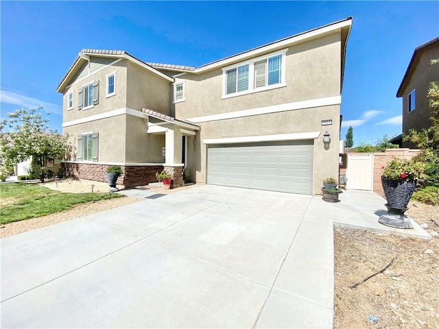 1011 Balsam St, Calimesa, CA 92320 - view of front of home featuring stone siding, an attached garage, stucco siding, and driveway
