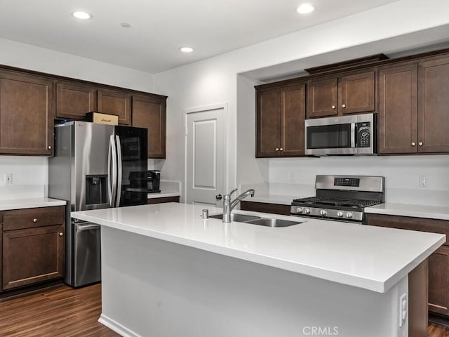29425 Bovenzi Way, Winchester, CA 92596 - kitchen with appliances with stainless steel finishes, dark brown cabinetry, light countertops, dark wood-style floors, and recessed lighting