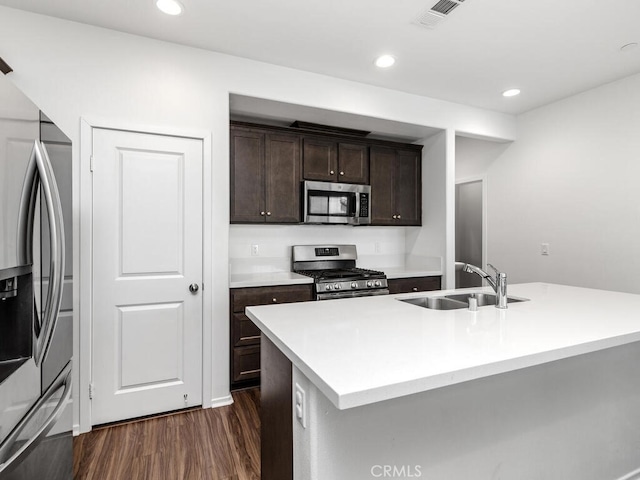29425 Bovenzi Way, Winchester, CA 92596 - kitchen with stainless steel appliances, dark wood finished floors, dark brown cabinetry, light countertops, and recessed lighting