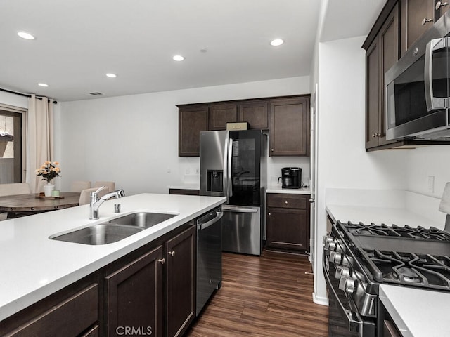 29425 Bovenzi Way, Winchester, CA 92596 - kitchen with appliances with stainless steel finishes, light countertops, dark wood-style floors, recessed lighting, and dark brown cabinetry