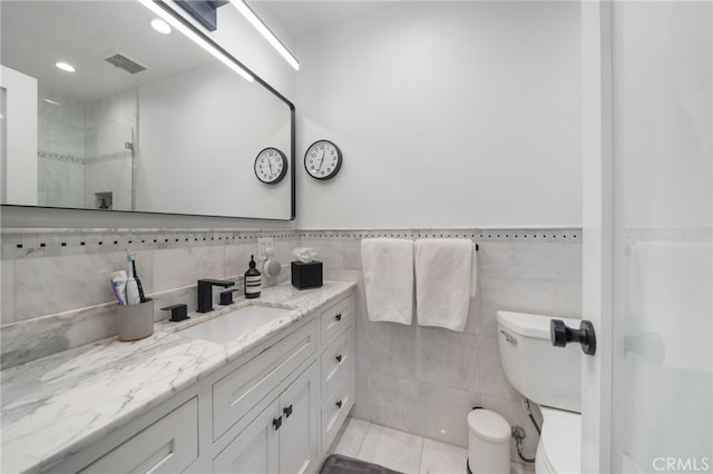 3407 Huxley St Unit 31, Los Angeles, CA 90027 - bathroom featuring vanity, tile walls, a tile shower, tile patterned flooring, and recessed lighting