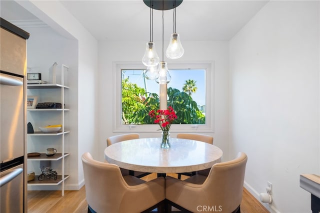 3407 Huxley St Unit 31, Los Angeles, CA 90027 - dining area featuring light wood finished floors and baseboards