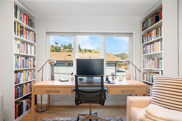 3407 Huxley St Unit 31, Los Angeles, CA 90027 - home office with ornamental molding, wood finished floors, and bookshelves