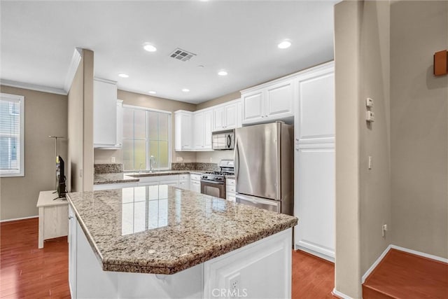 2019 Arnold Way, Fullerton, CA 92833 - kitchen featuring stainless steel appliances, light wood-style flooring, white cabinetry, light stone counters, and recessed lighting