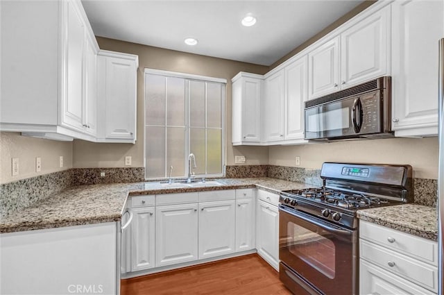 2019 Arnold Way, Fullerton, CA 92833 - kitchen with black appliances, white cabinets, light wood-style floors, recessed lighting, and light stone countertops