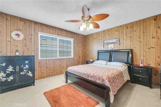 1135 Hampton Ct, San Dimas, CA 91773 - carpeted bedroom featuring wooden walls, a textured ceiling, and ceiling fan