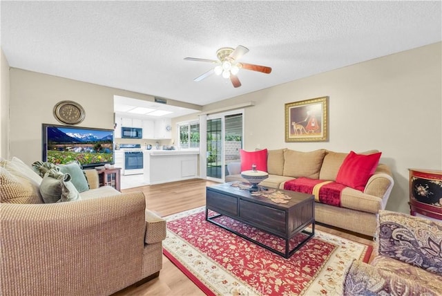 1135 Hampton Ct, San Dimas, CA 91773 - living room with light wood finished floors, ceiling fan, and a textured ceiling