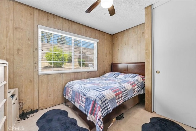 1135 Hampton Ct, San Dimas, CA 91773 - carpeted bedroom featuring wooden walls, multiple windows, a textured ceiling, and ceiling fan