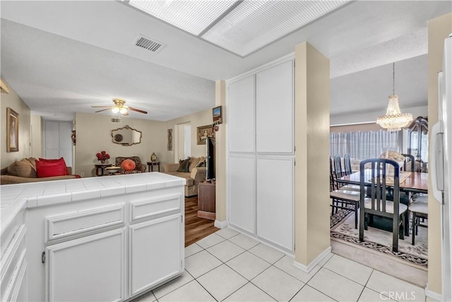 1135 Hampton Ct, San Dimas, CA 91773 - kitchen with open floor plan, tile counters, a chandelier, and light tile patterned floors
