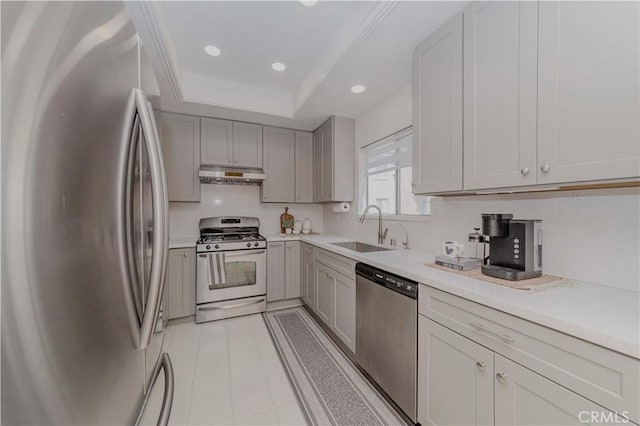 15034 Ocaso Ave, La Mirada, CA 90638 - kitchen with stainless steel appliances, under cabinet range hood, light countertops, a raised ceiling, and recessed lighting