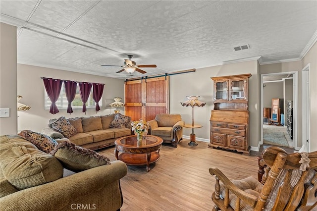 41050 Mohawk Cir, Cherry Valley, CA 92223 - living room with a barn door, light wood-type flooring, crown molding, and a ceiling fan