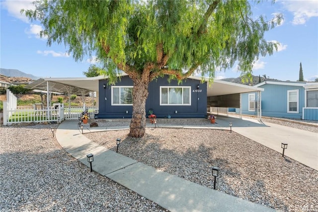 41050 Mohawk Cir, Cherry Valley, CA 92223 - manufactured / mobile home with an attached carport and driveway