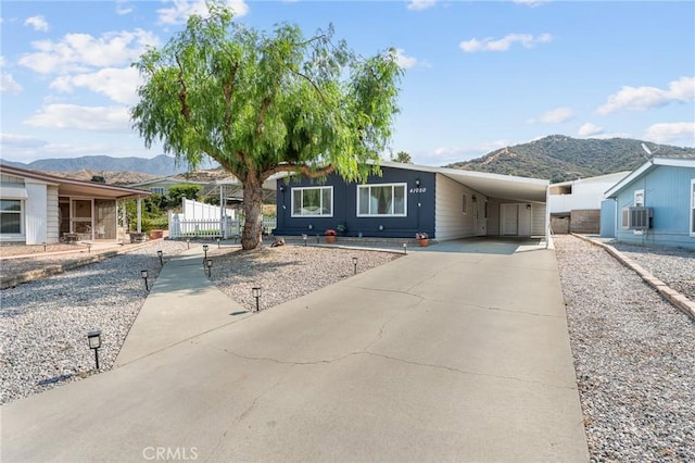 41050 Mohawk Cir, Cherry Valley, CA 92223 - manufactured / mobile home with a mountain view, a carport, and driveway