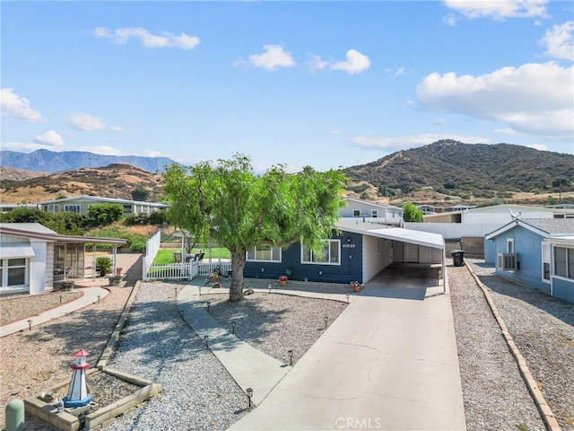 41050 Mohawk Cir, Cherry Valley, CA 92223 - view of front facade with an attached carport, a mountain view, and driveway