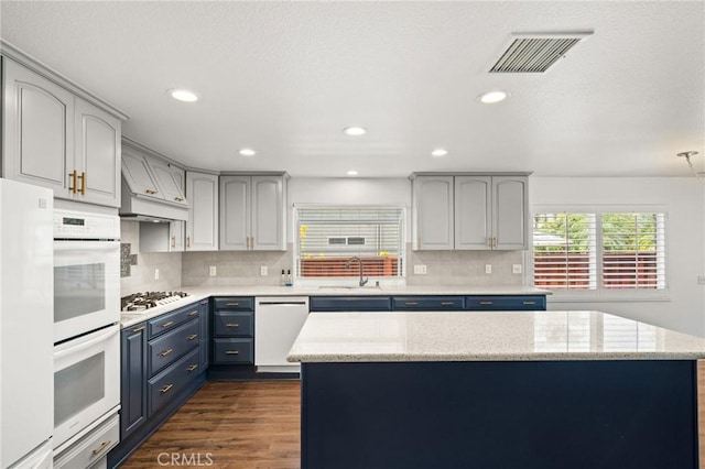 1167 Belridge Pl, Corona, CA 92881 - kitchen featuring white appliances, blue cabinetry, premium range hood, backsplash, and dark wood-type flooring