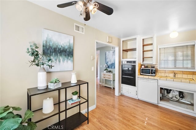 6182 Anthony Ave, Garden Grove, CA 92845 - kitchen featuring white dishwasher, stainless steel microwave, tile counters, light wood-style flooring, and ceiling fan