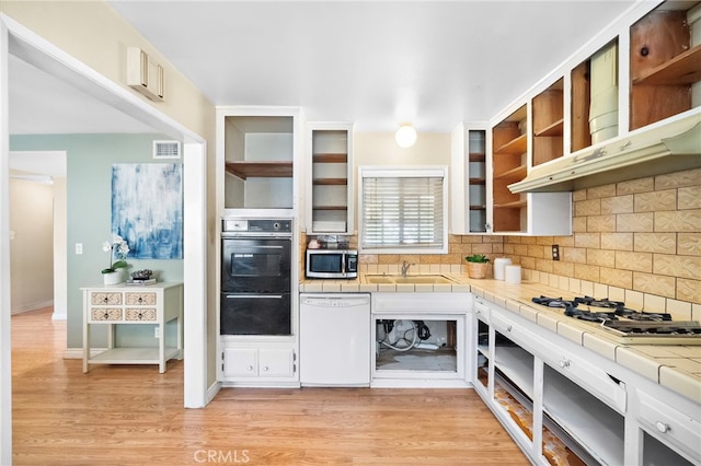 6182 Anthony Ave, Garden Grove, CA 92845 - kitchen featuring white appliances, open shelves, tile countertops, tasteful backsplash, and light wood-style floors