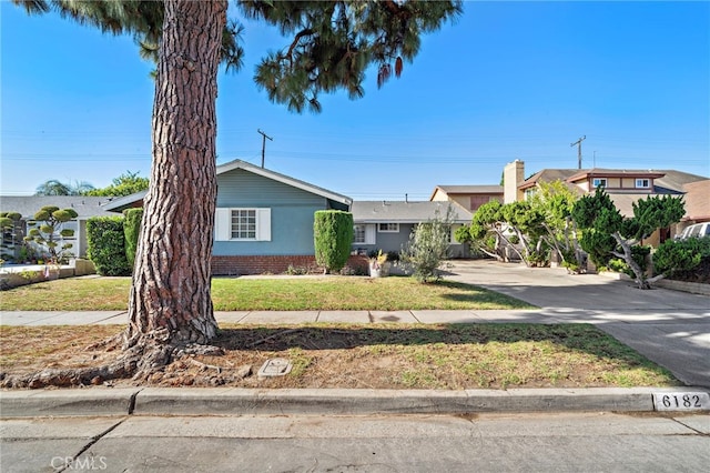 6182 Anthony Ave, Garden Grove, CA 92845 - view of front facade featuring a front lawn and a chimney