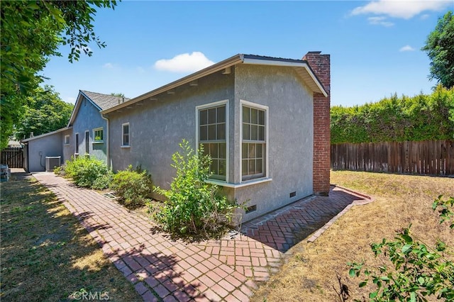 15747 Addison St, Encino, CA 91436 - view of side of home with stucco siding, a chimney, and crawl space