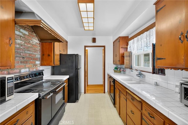 15747 Addison St, Encino, CA 91436 - kitchen featuring black appliances, tile counters, brown cabinetry, light floors, and backsplash