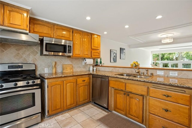 4320 W Kling St Unit 27, Burbank, CA 91505 - kitchen featuring appliances with stainless steel finishes, under cabinet range hood, brown cabinets, light tile patterned flooring, and backsplash