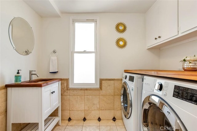 4320 W Kling St Unit 27, Burbank, CA 91505 - washroom featuring independent washer and dryer, cabinet space, a wainscoted wall, tile walls, and light tile patterned floors
