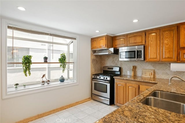 4320 W Kling St Unit 27, Burbank, CA 91505 - kitchen with appliances with stainless steel finishes, range hood, brown cabinets, stone counters, and decorative backsplash